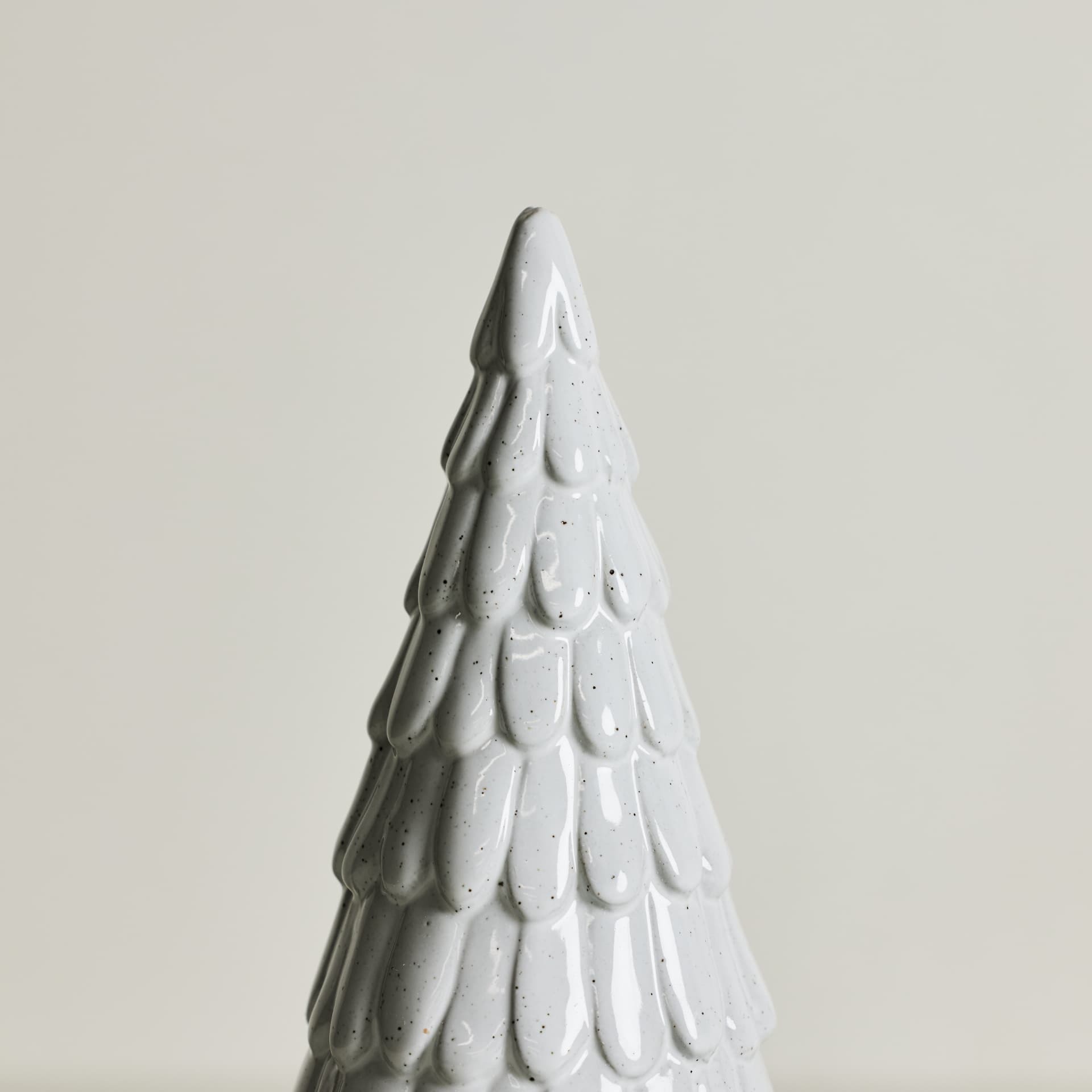 Close crop of the speckled glaze on a ceramic Christmas tree
